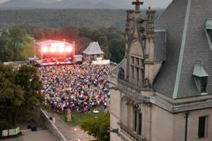 Concert crowd from above the Biltmore House with blue mountains behind